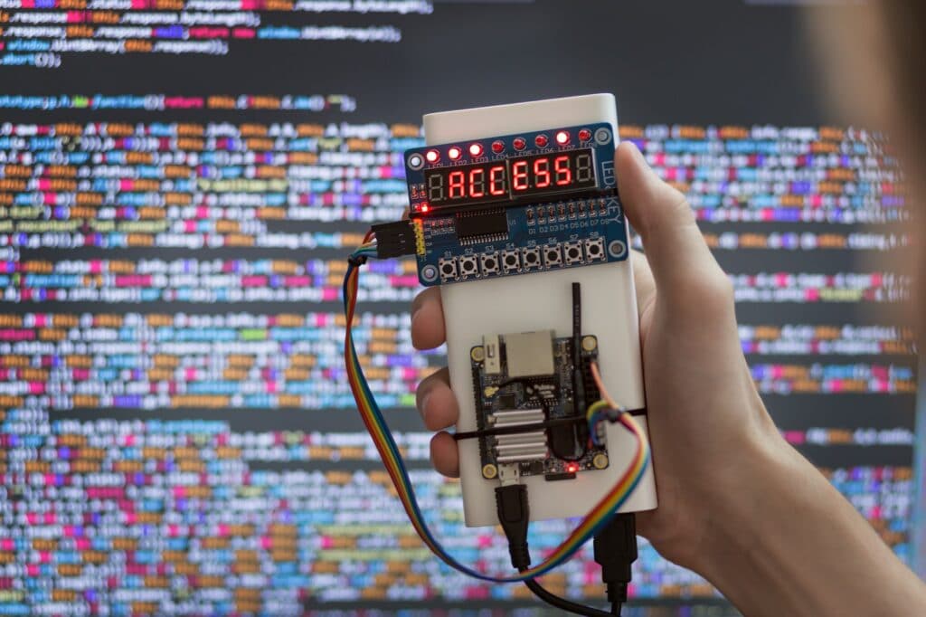 hand of hacker with electronic password cracking device close up